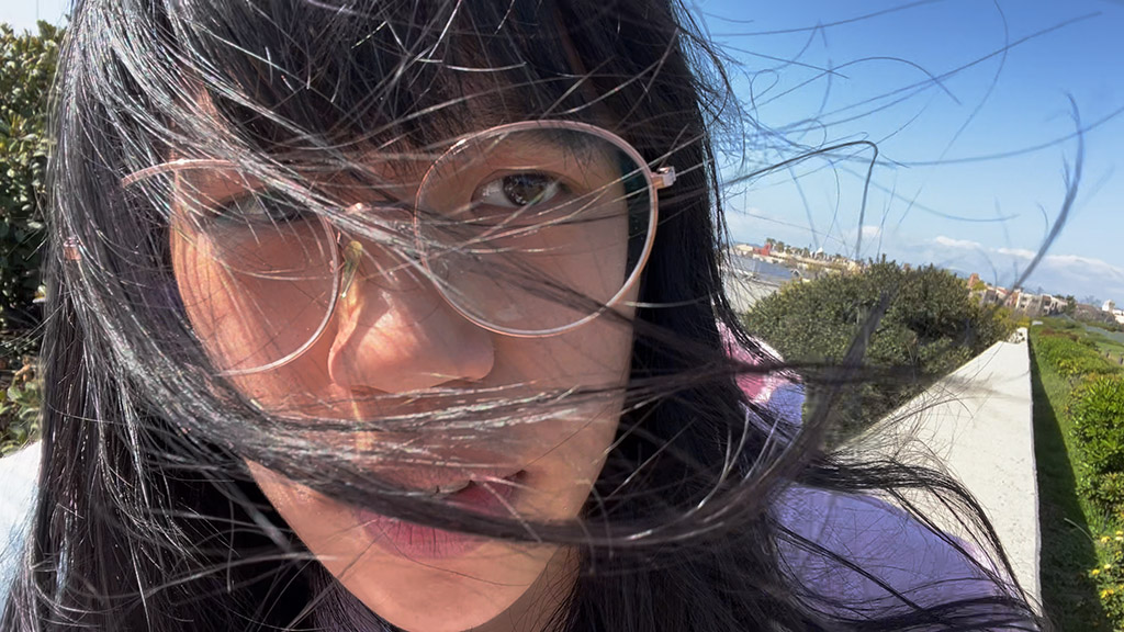 Woman's hair being blown by wind outside